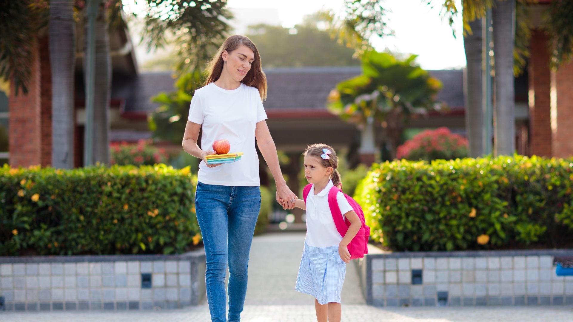mother and daughter walking hand in hand.